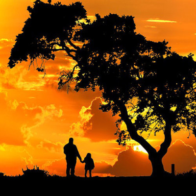 Father with daughter in the sunset
