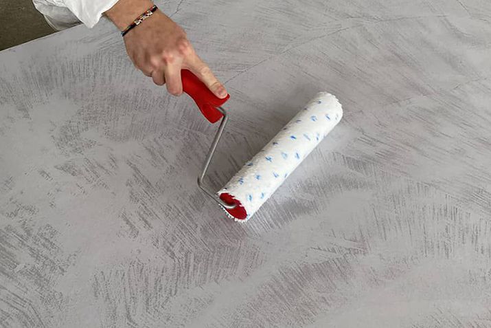 Close-up view of clear sealer application on Microbond decorative mortar floor