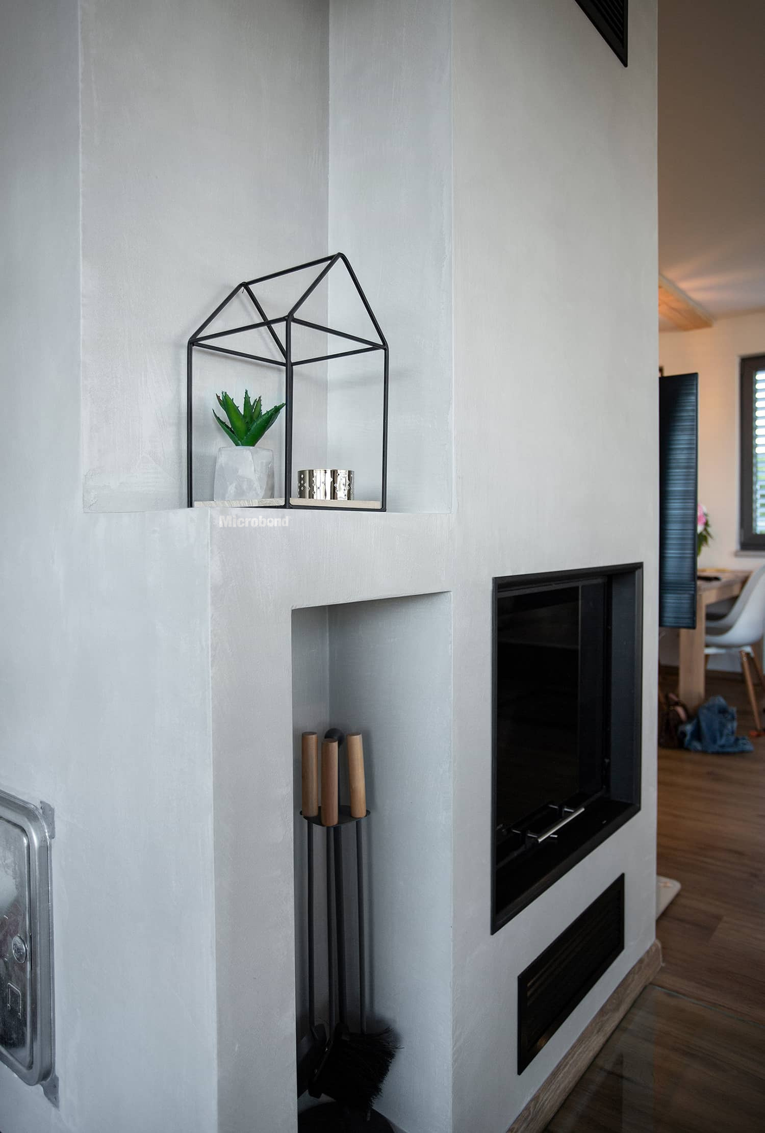 Built-in fireplace walls overlayed with decorative microcement Microbond