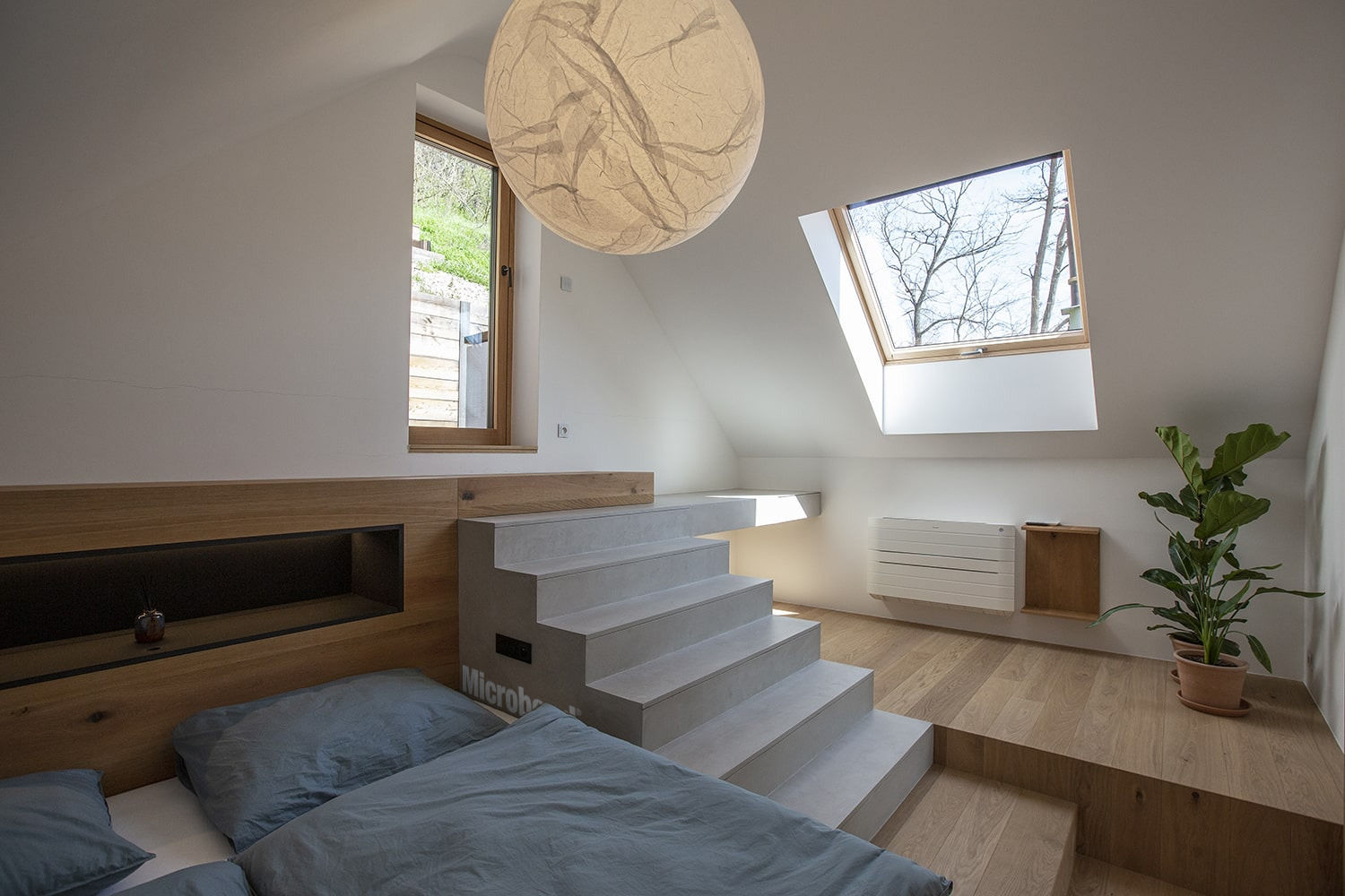 Small Microbond staircase matching the wooden floor of the room