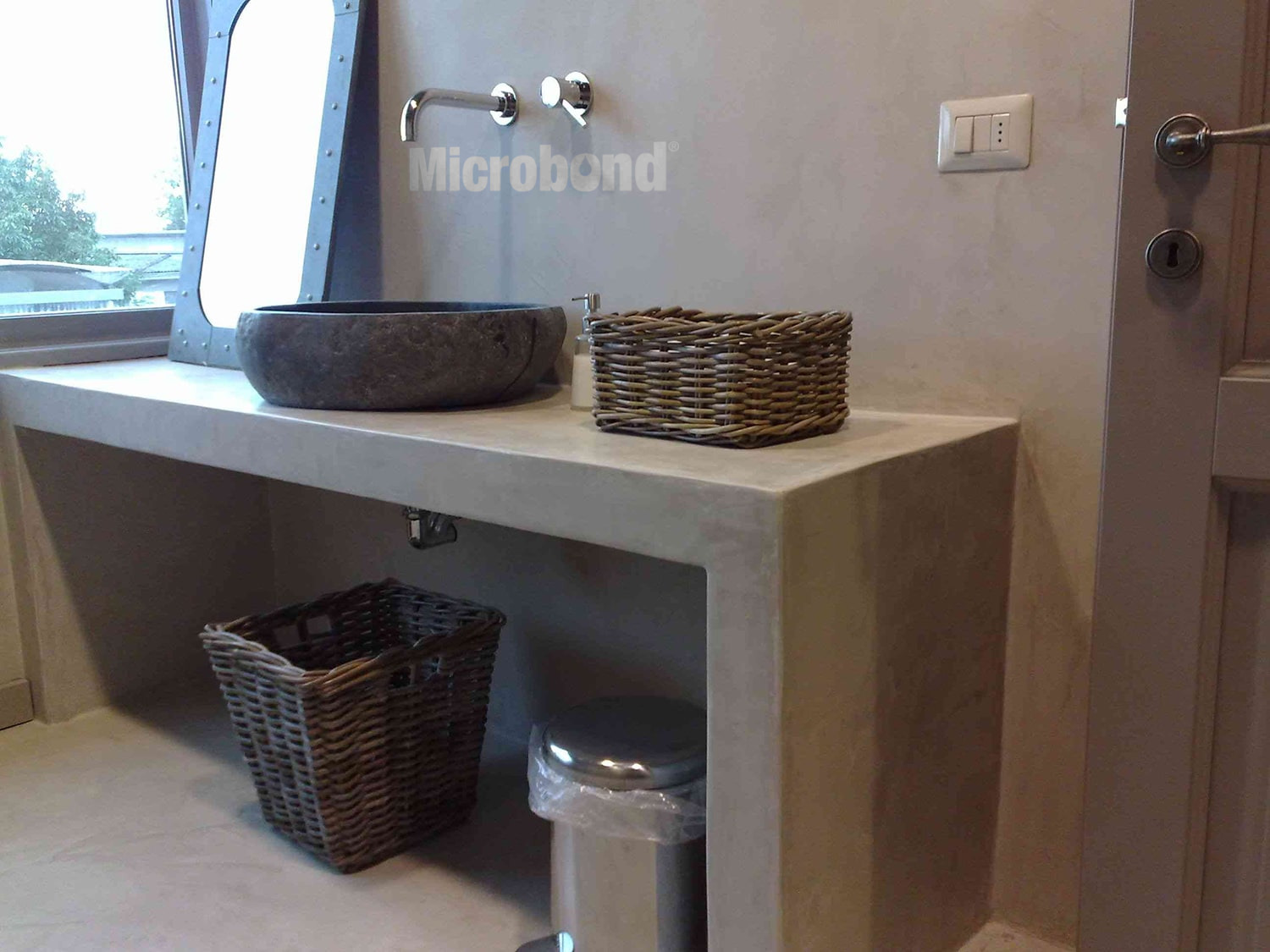 Bathroom and sink cabinet seamlessly covered with rustic-style decorative mortar