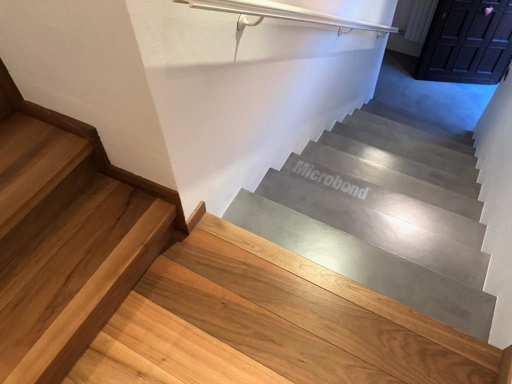 Microbond staircase that connects to a wooden staircase